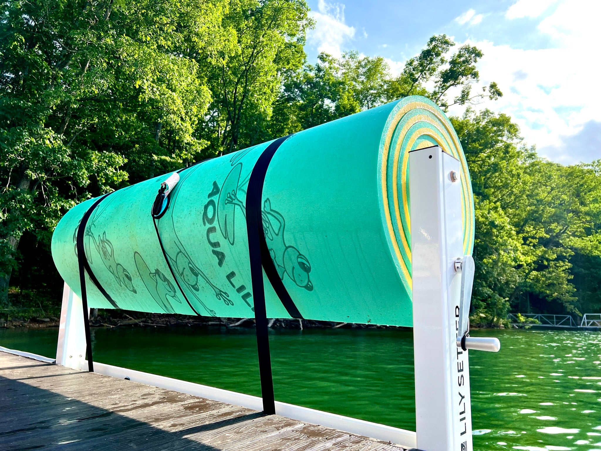 People struggle to roll up lily pads and are always asking what is the best way to roll up a lily pad or where can i find a lily pad holder. This Dock Setter pritured here, manufactured by Lily Setter, shows their system designed for Pontoon boats and docks that rolls Lily Pads, Straps them, Lifts them and stores them. Aqua Lily Pad, Lily Pad featured here.
